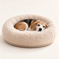 RestWell cuddler donut dog bed in cream faux fur, studio photo with a dog